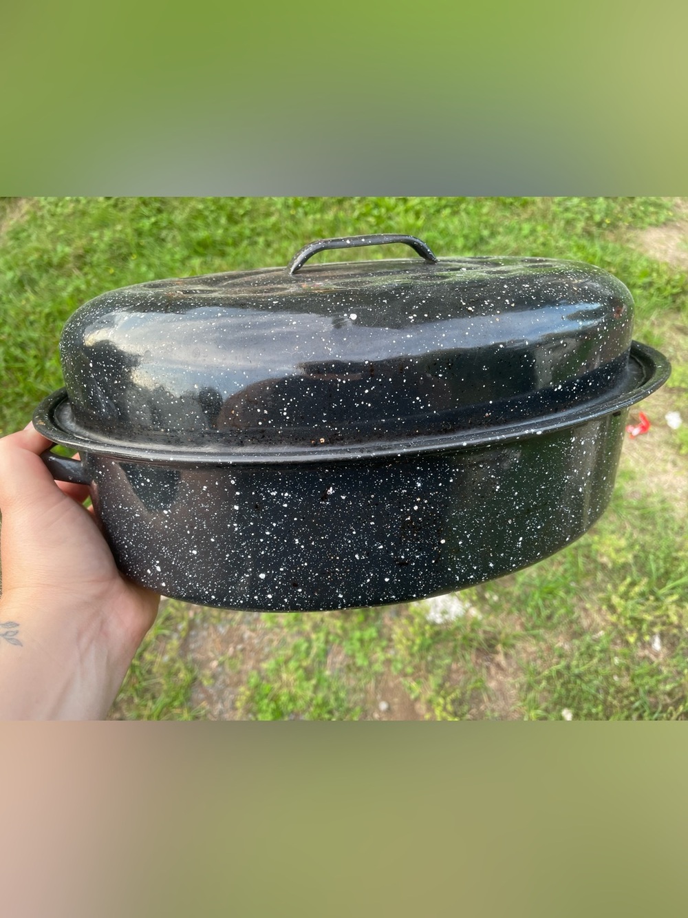 black-and-white speckled enamelware oval roasting pan with a matching domed lid